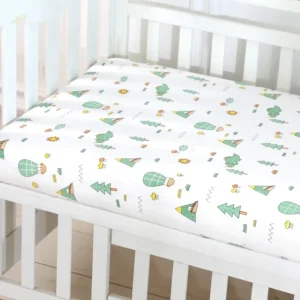 A crib with a white sheet and cactus print.