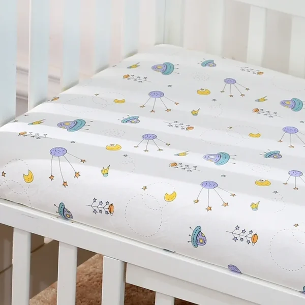 A crib with sheets on it and the bottom of the mattress.