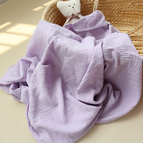 A purple blanket in the shape of a teddy bear.